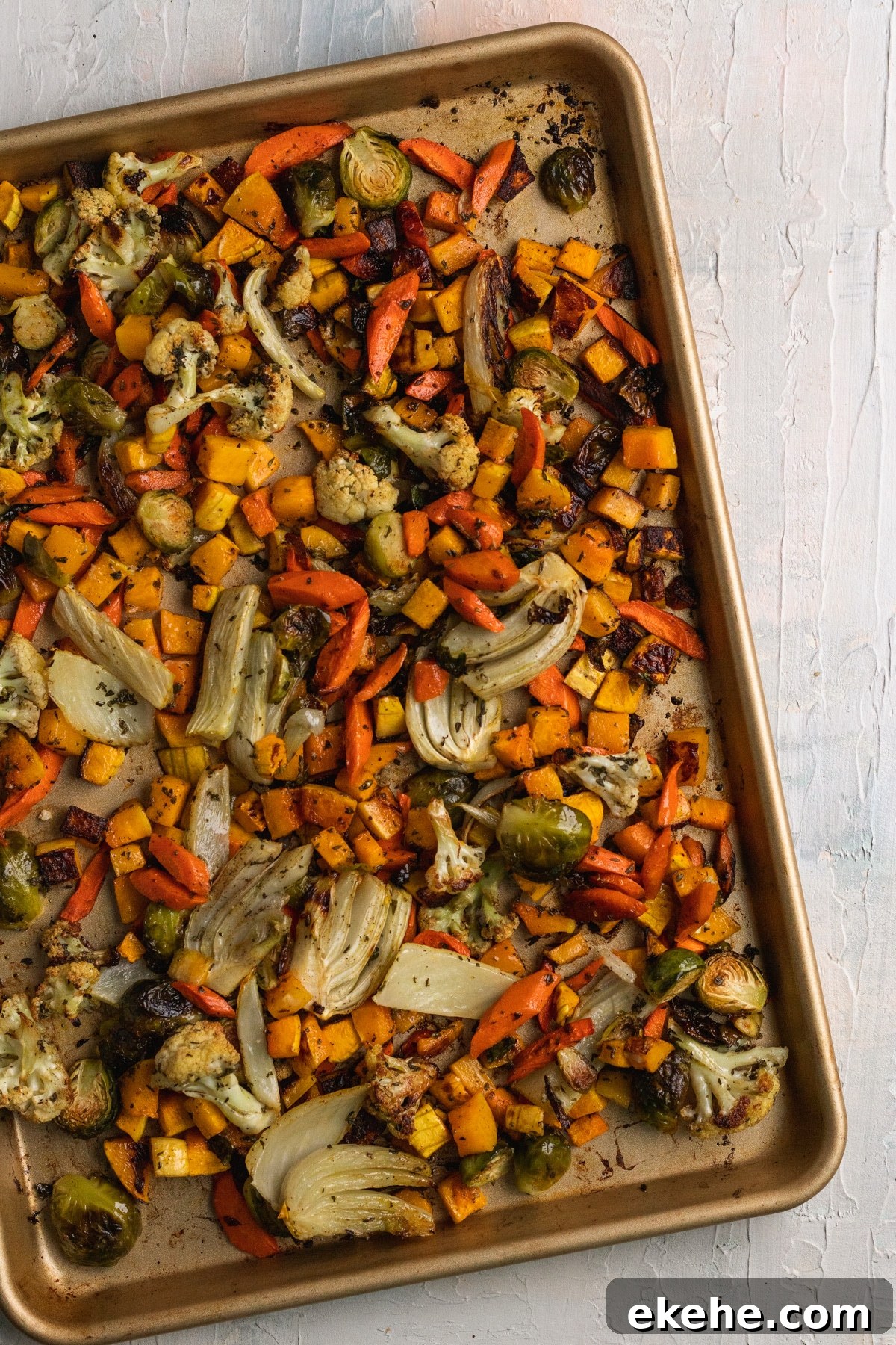 roasted veggies on a gold sheet pan.