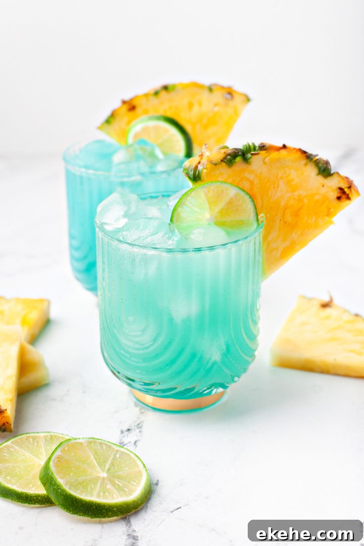 photos of a blue hawaiian (blue curacao cocktail) in glasses garnished with pineapple and lime slices 