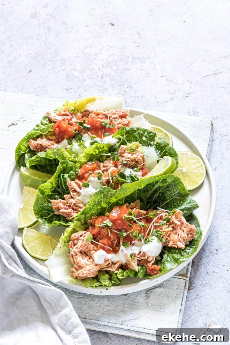 salsa chicken lettuce wraps served on a white plate with lime wedges