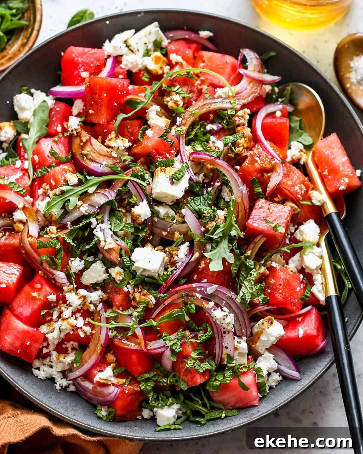 Feta Watermelon Salad in a serving bowl with salad servers