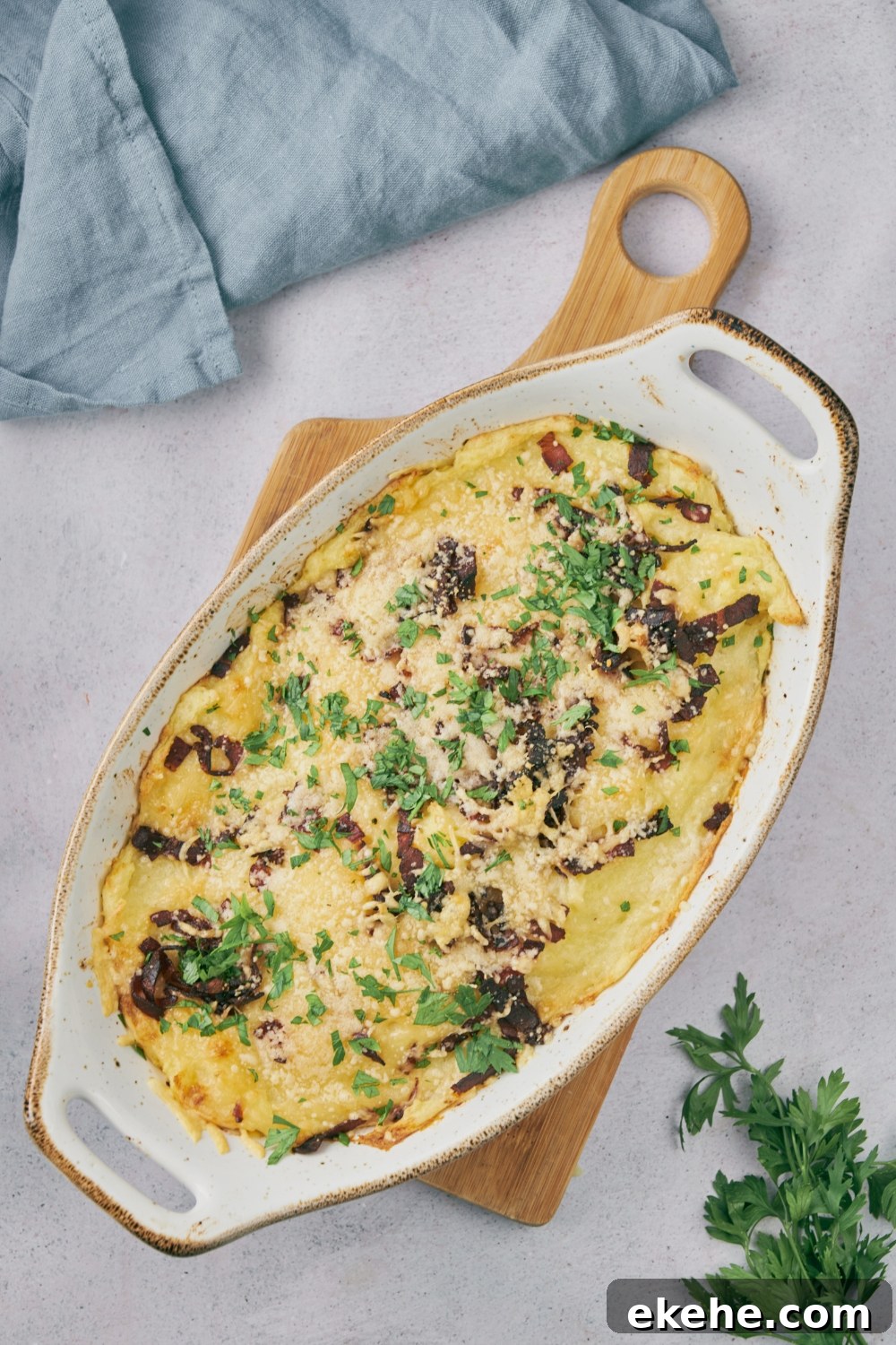 Cooked meatloaf casserole in a white serving dish with garnish