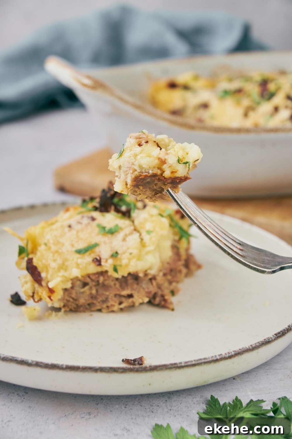 A fork full of cooked meatloaf casserole