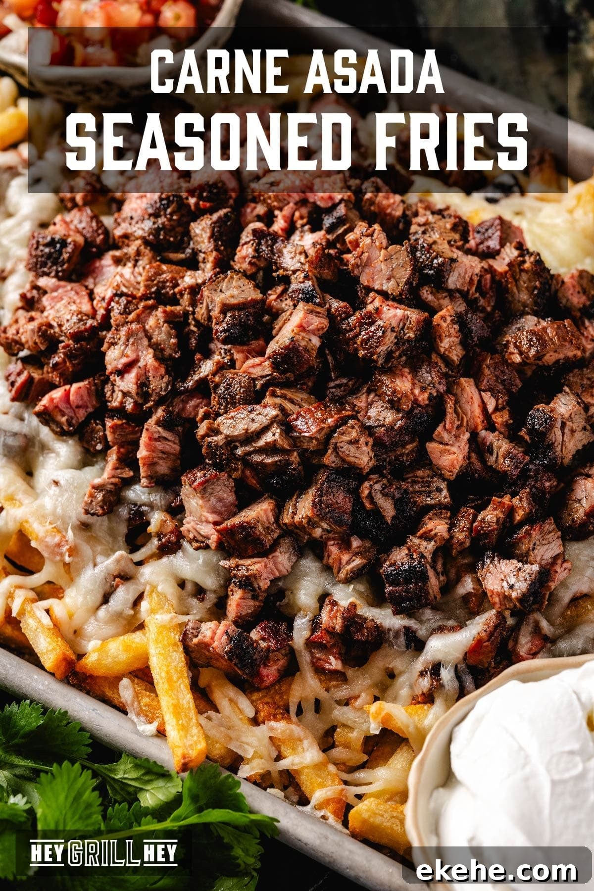 A baking sheet with loaded fries. The text overlay reads 'Carne Asada Seasoned Fries' at the top, and 'Hey Grill Hey' at the bottom.