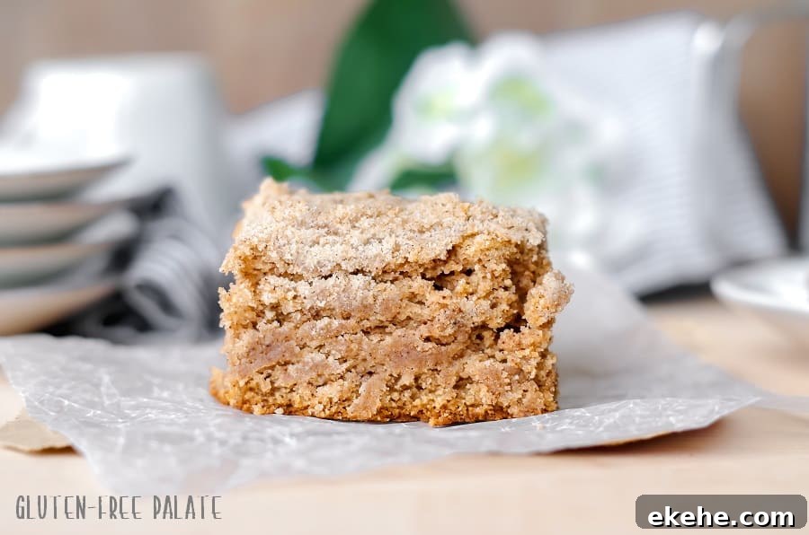 a slice of gluten free chai coffee cake on a piece of parchment paper