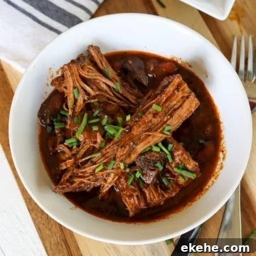 Fall apart eye of round roast in a white bowl