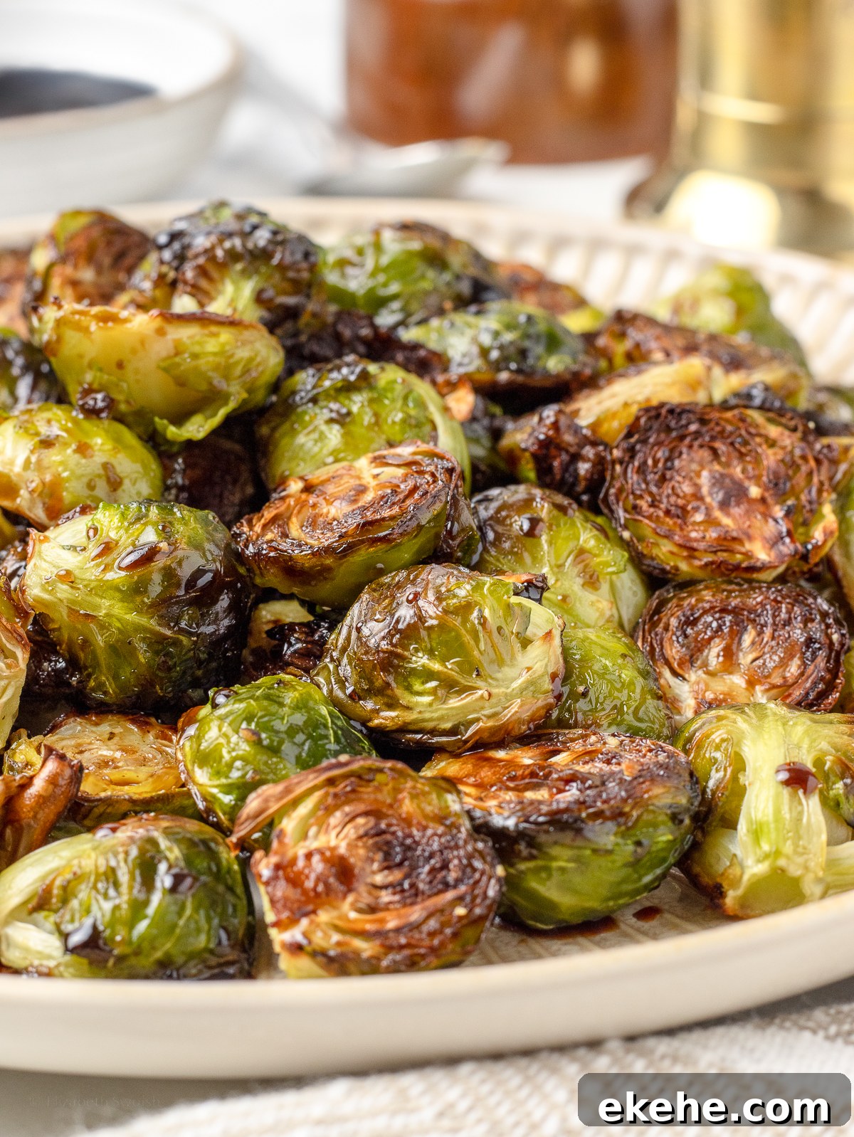 Close up of the brussels sprouts to see their crispy, caramelized edges, and the light coating of balsamic honey sauce.