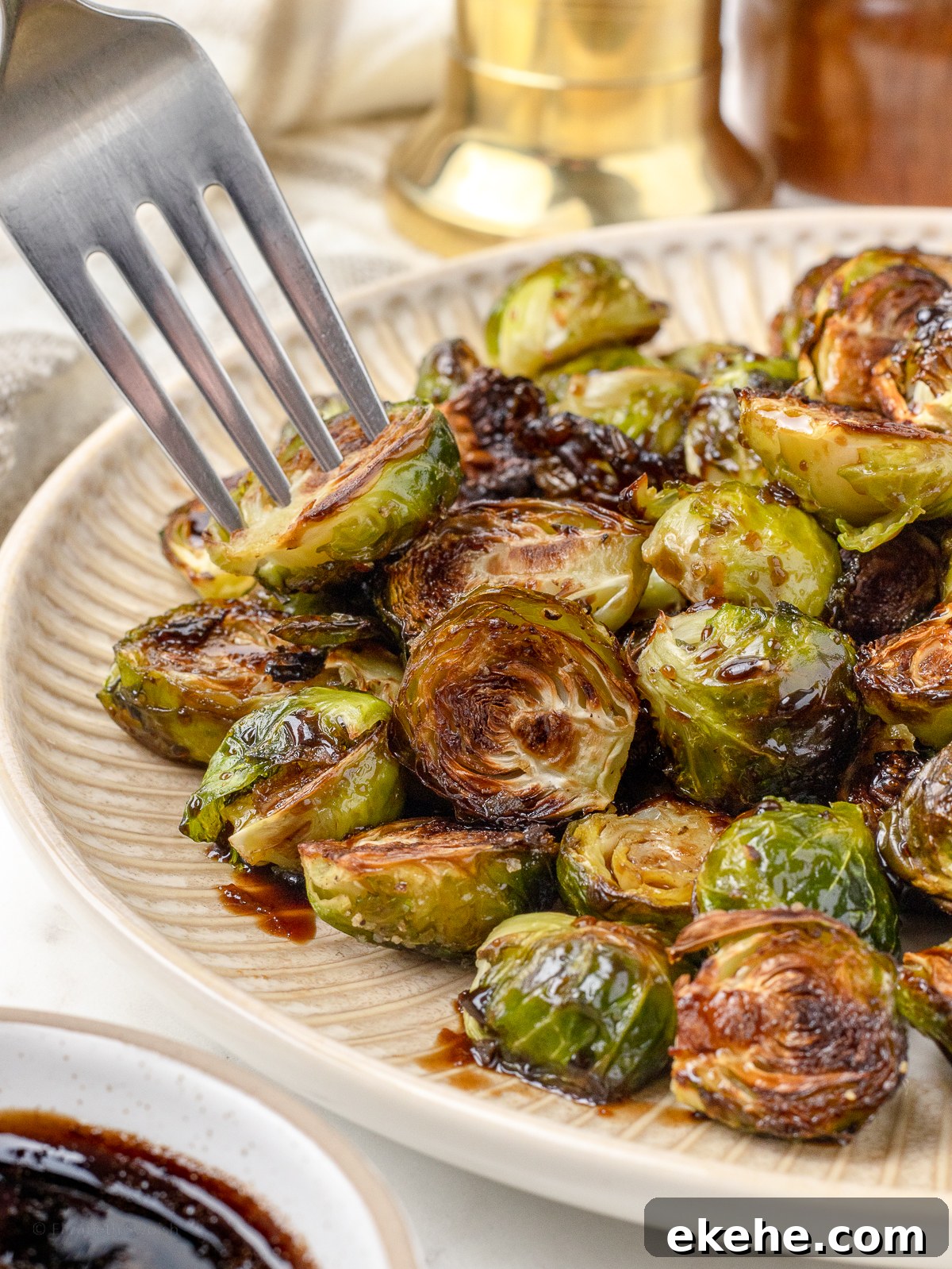 Fork grabbing a roasted brussels sprouts from the platter.