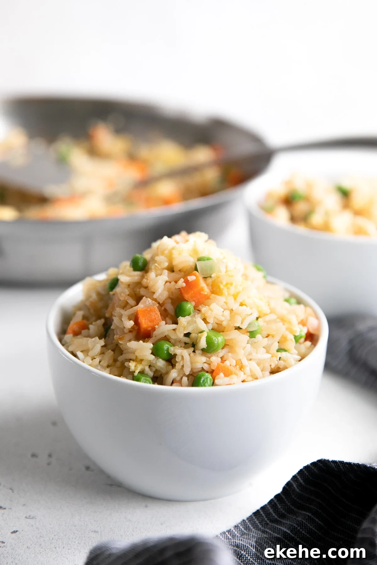 Small white bowl filled with fried rice.