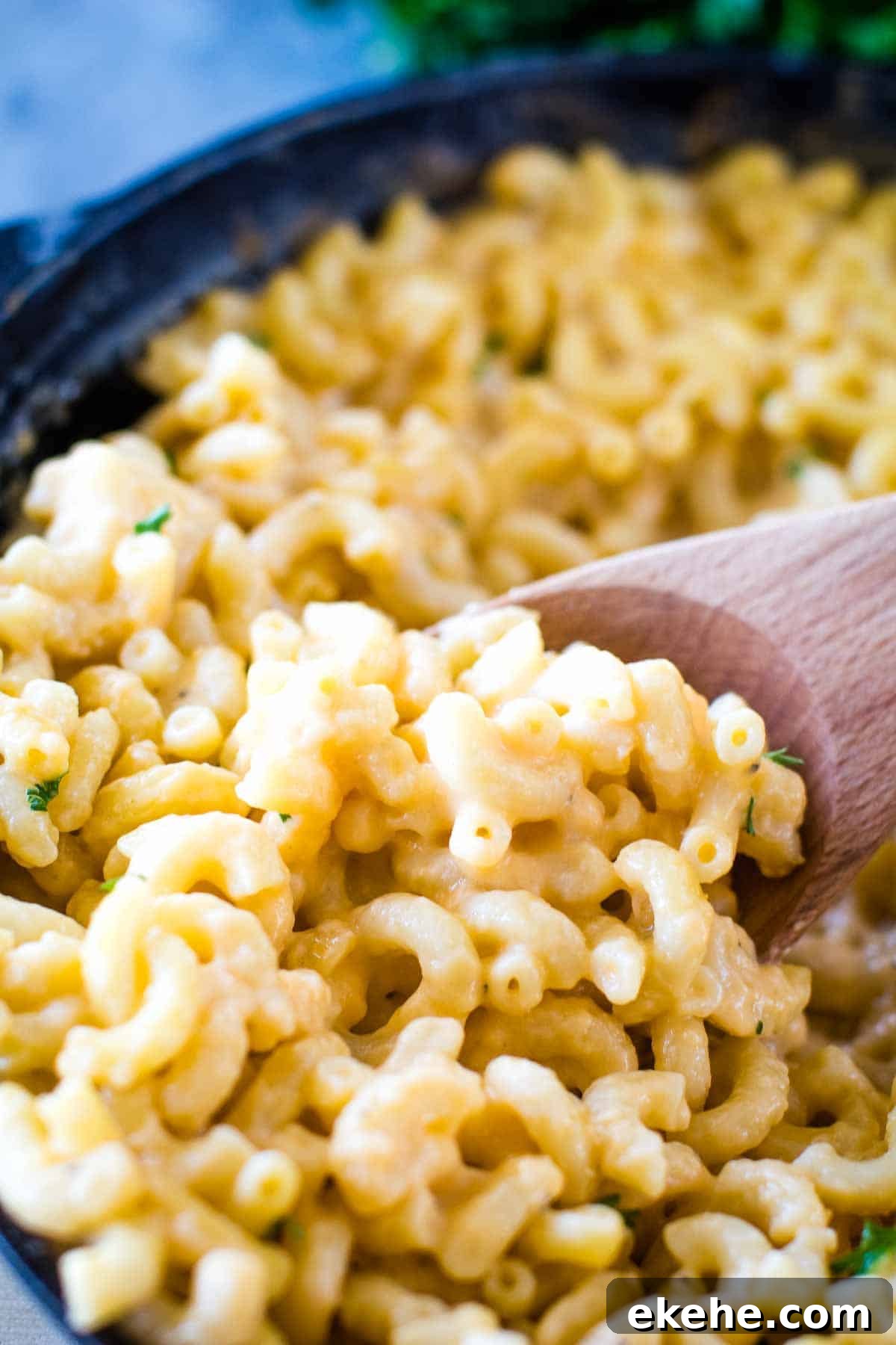 Wooden spoon scoopin Smoked Mac and Cheese