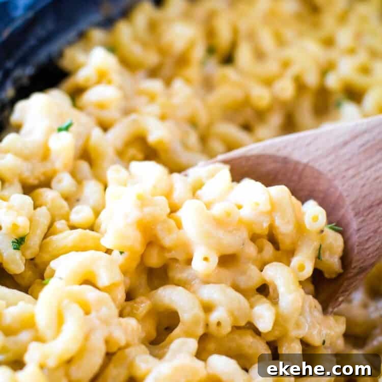 Wooden spoon scoopin Smoked Mac and Cheese