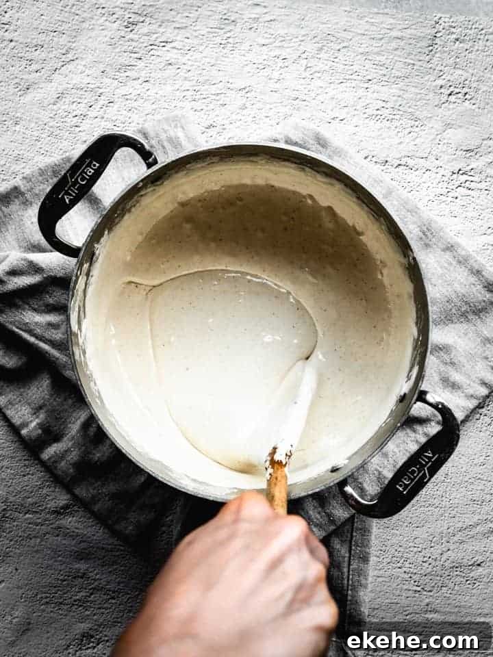 mixing marshmallows into browned butter to make s'mores Rice Krispie Treats