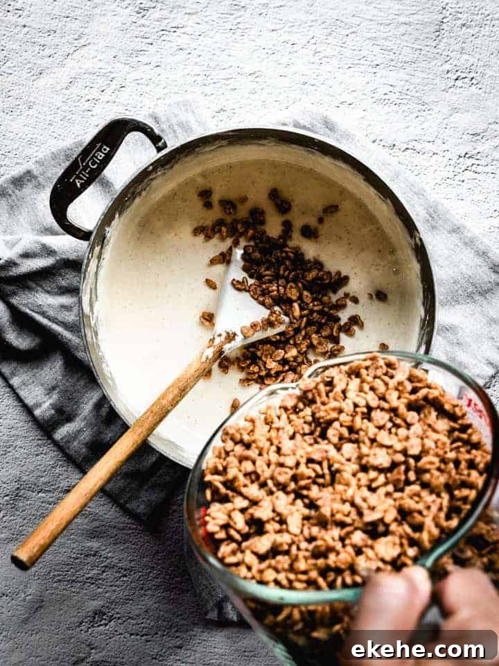 mixing cocoa Krispies into melted marshmallow and browned butter to make s'mores Rice Krispie treats