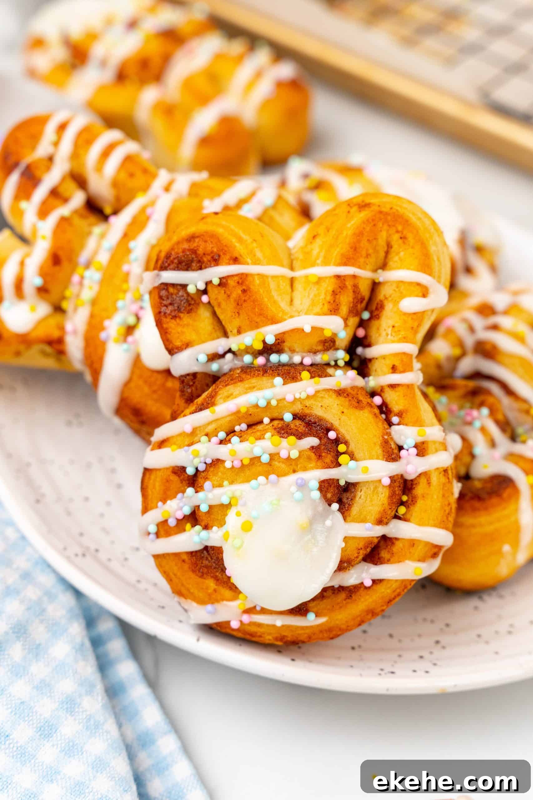 Easter bunny cinnamon buns on a white speckled plate