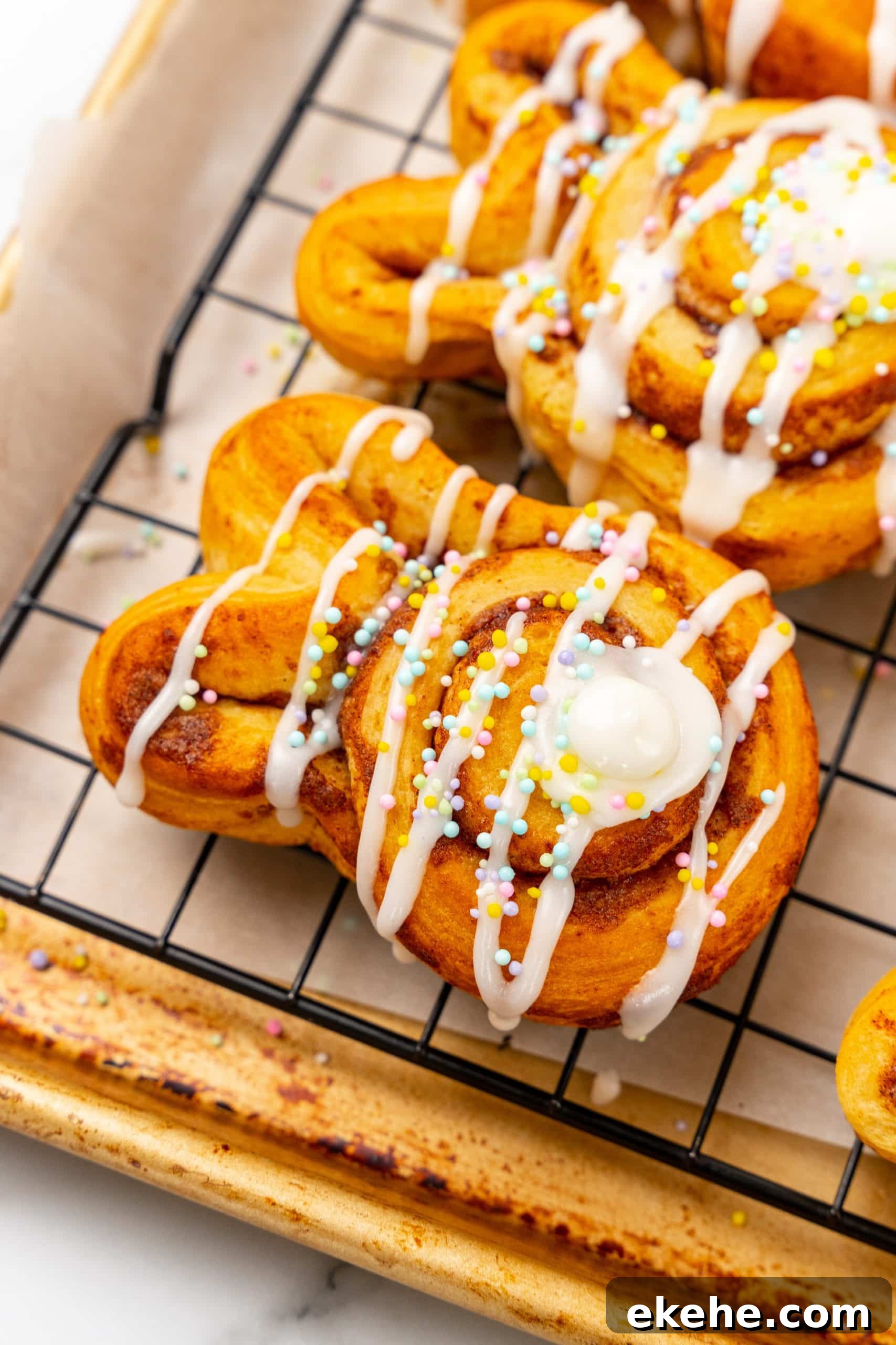 frosted bunny cinnamon rolls on a wire cooling rack