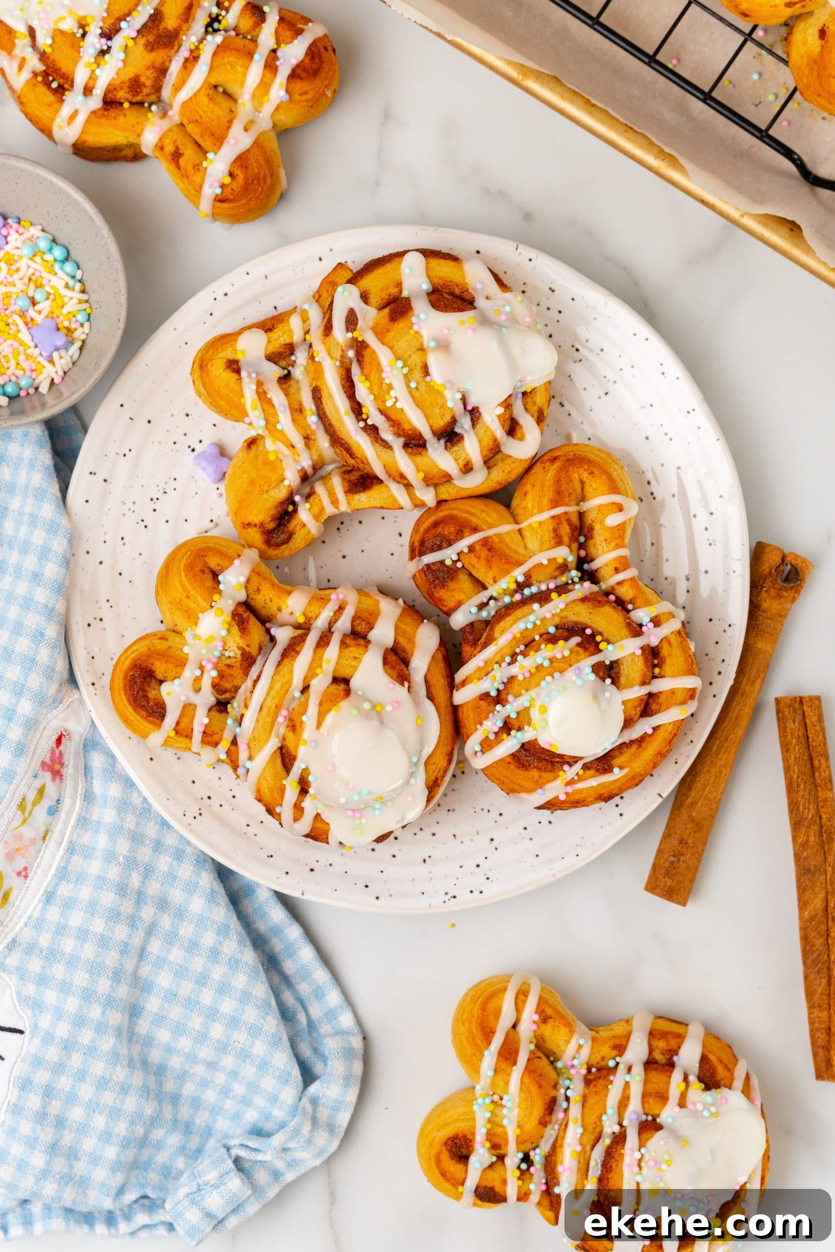 Easter bunny cinnamon buns on a white speckled plate