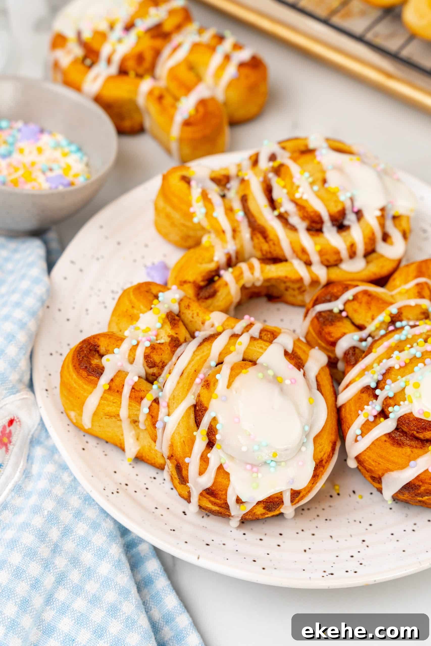 Easter bunny cinnamon buns on a white speckled plate
