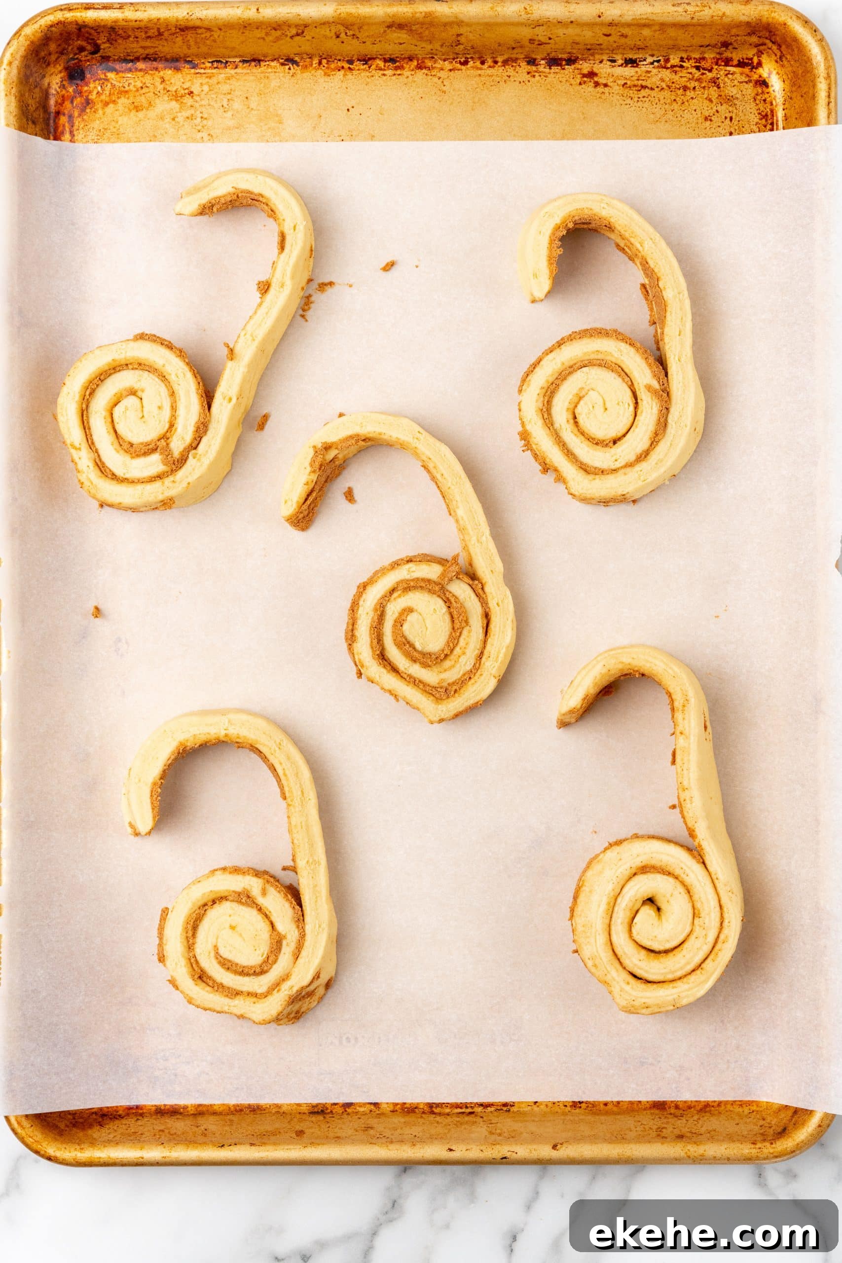 spread apart canned cinnamon rolls on a parchment paper lined baking sheet