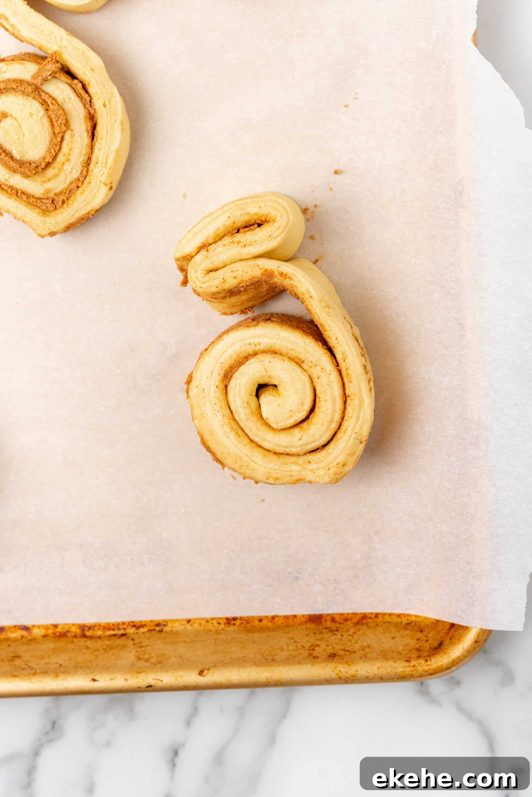 spread apart canned cinnamon rolls on a parchment paper lined baking sheet