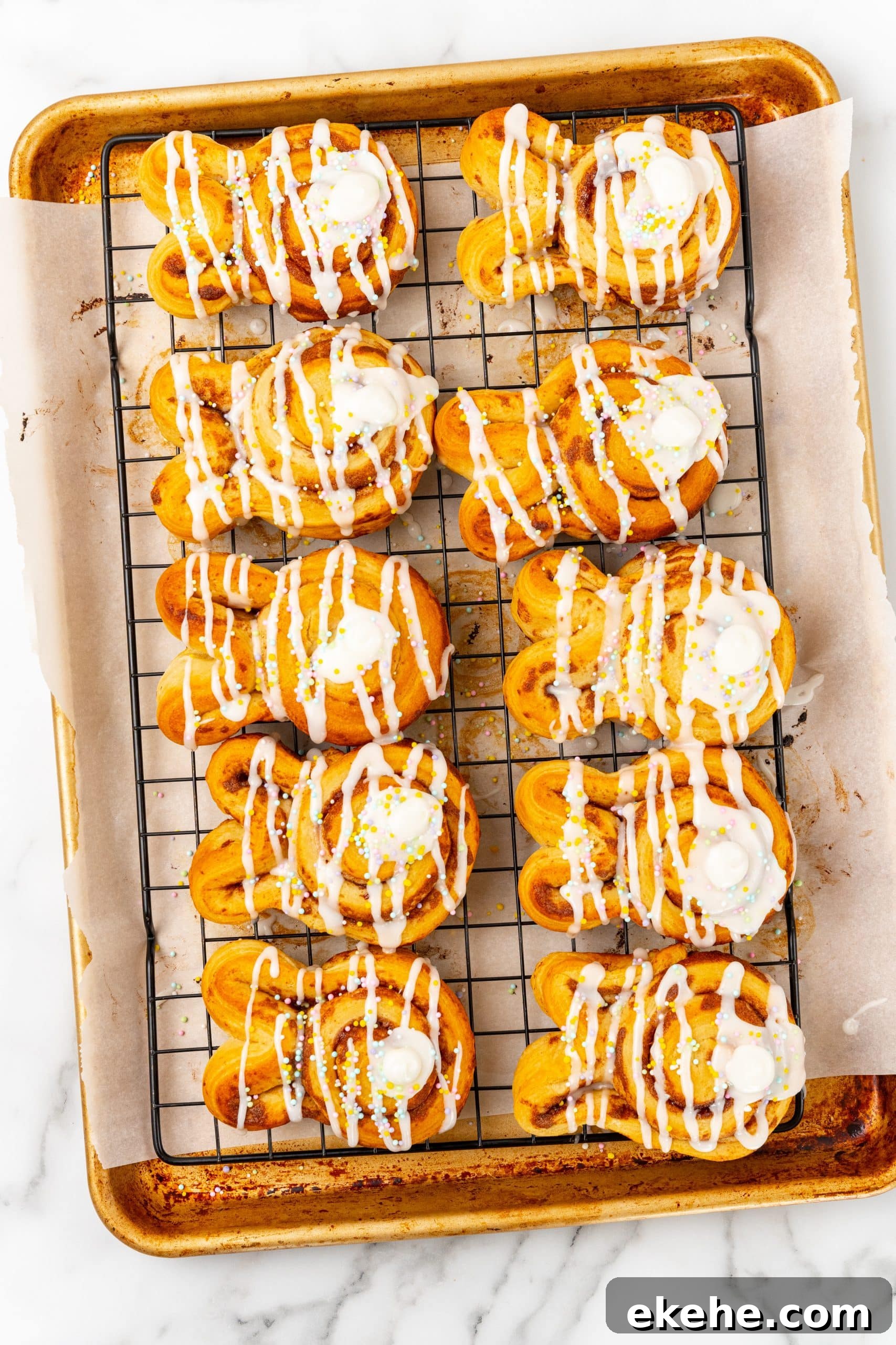 frosted bunny cinnamon rolls on a wire cooling rack