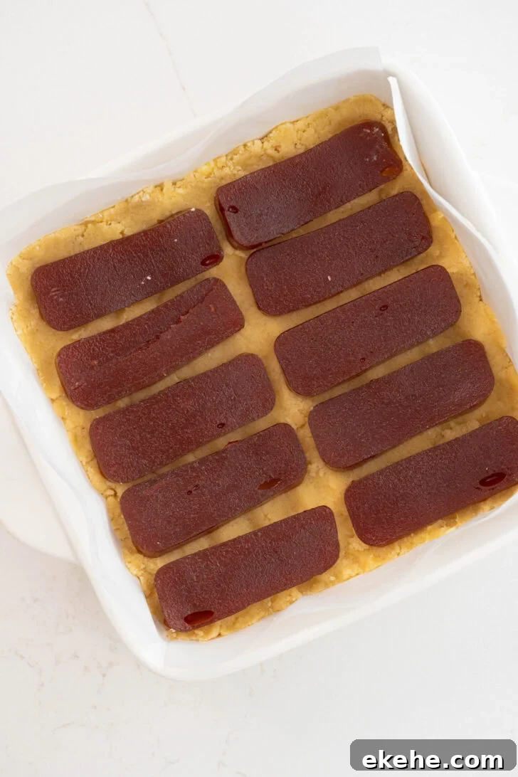 Guava bars being assembled in a baking dish.