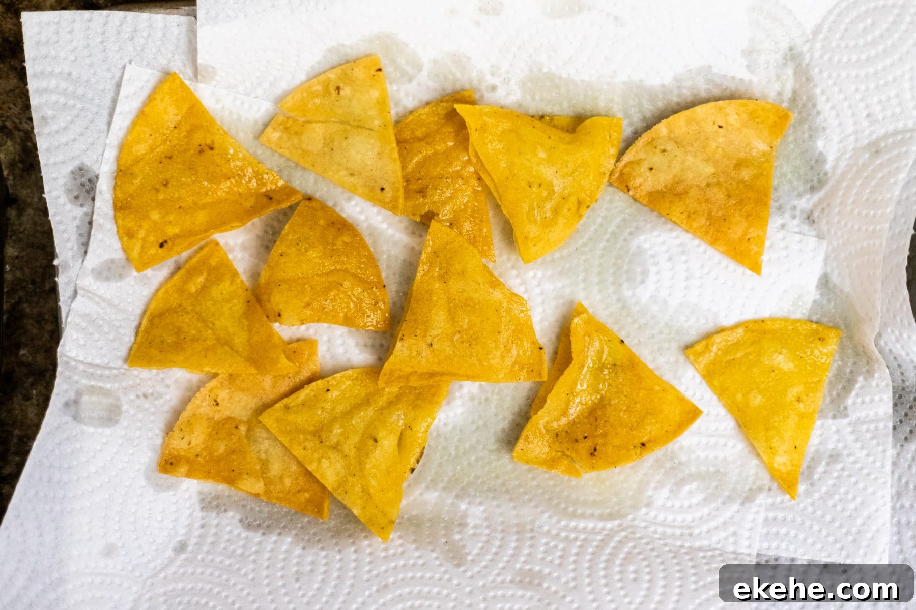 Corn tortilla chips resting on paper towel.