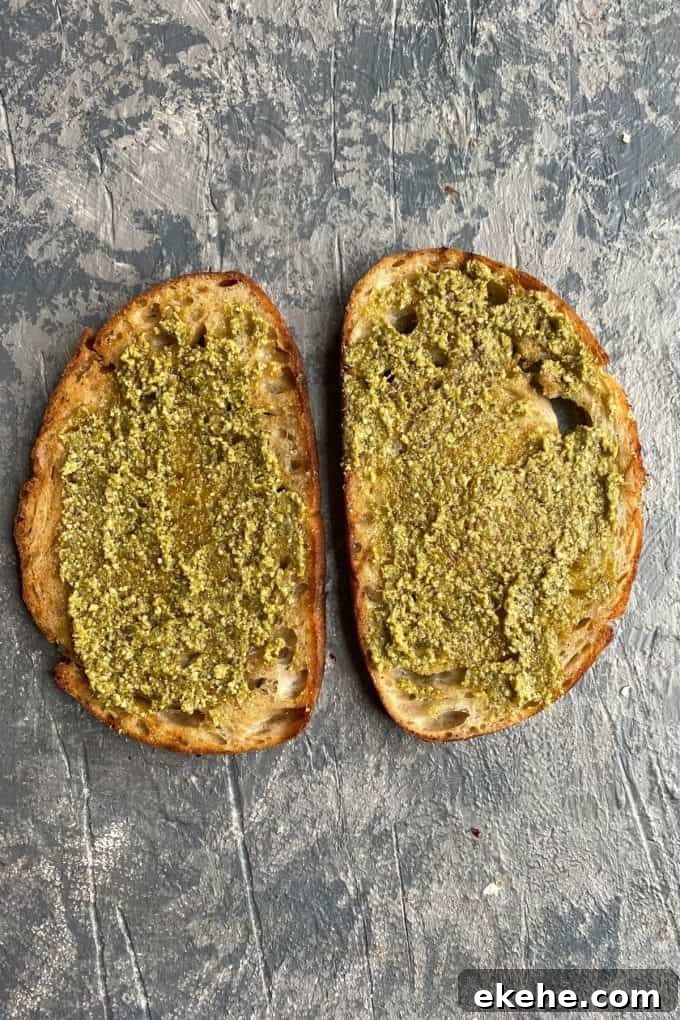 Two slices of toasted sourdough with pesto