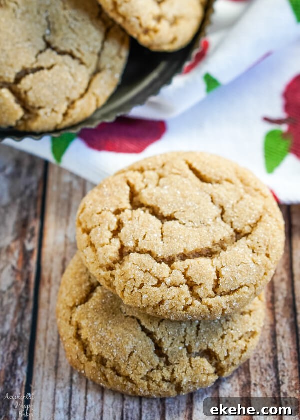 A stack of two cookies sitting in front of a plate of french toast cookies.