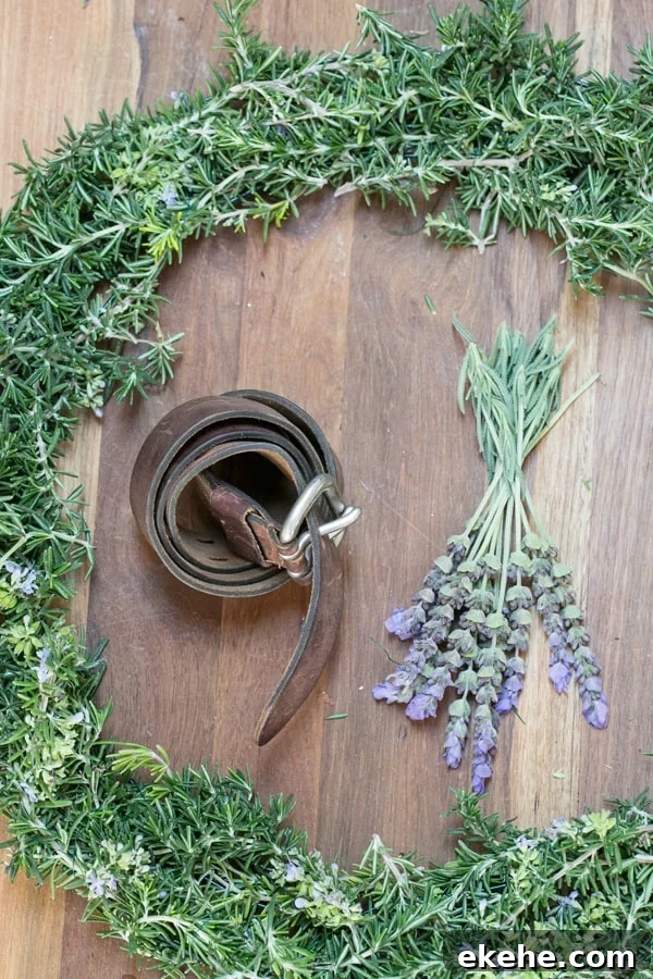 shot of materials for rustic rosemary wreath - rosemary wreath, rosemary sprigs, rosemary wreaths, green floral wire, both rosemary