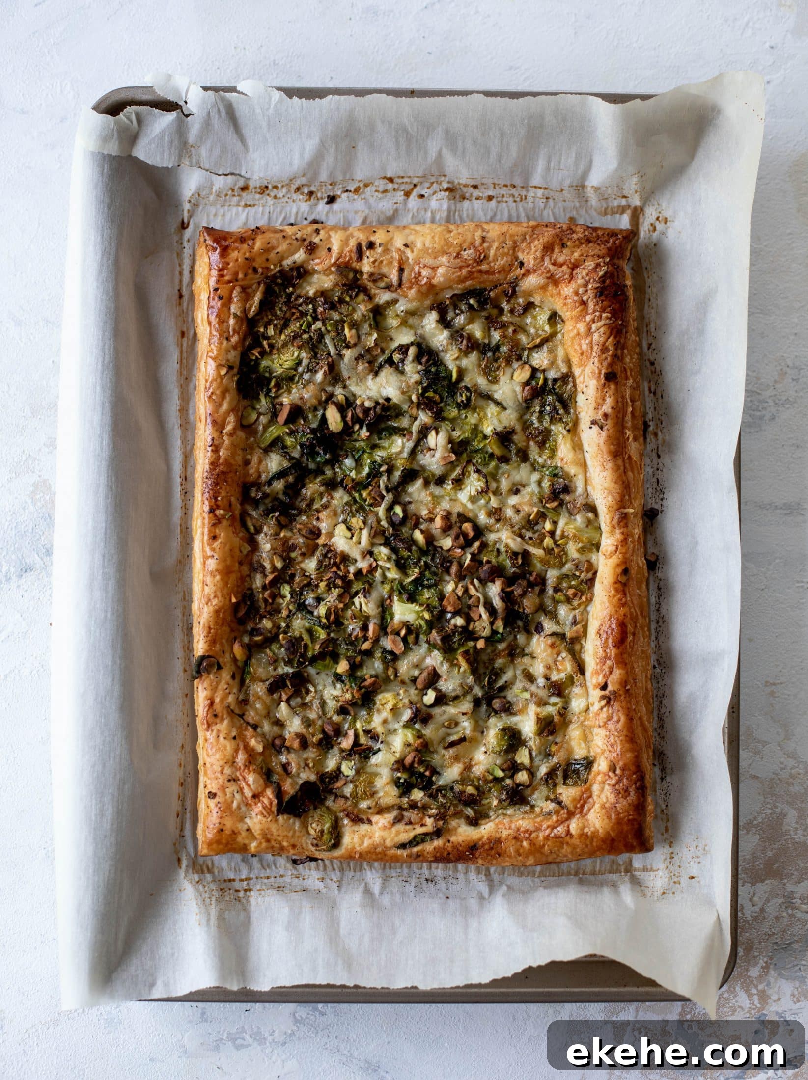 This brussels sprouts tart has a ton of flavor! Melty fontina, sliced brussels and crunchy pistachios all on top of puff pastry. Delish!