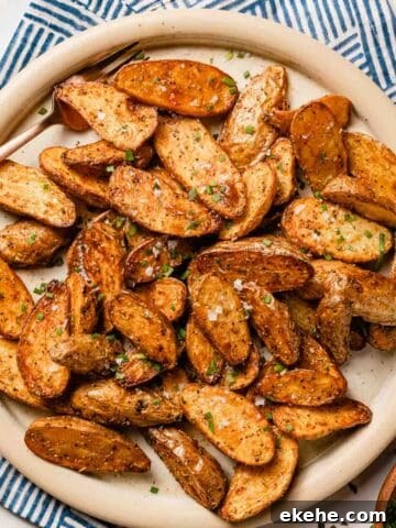 halved fingerling potatoes on plate with fork on the side
