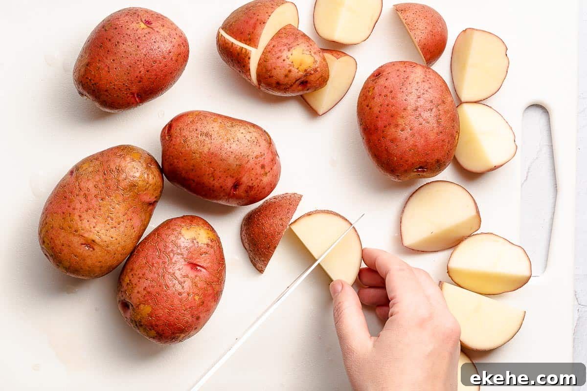 potatoes being cut into chunks