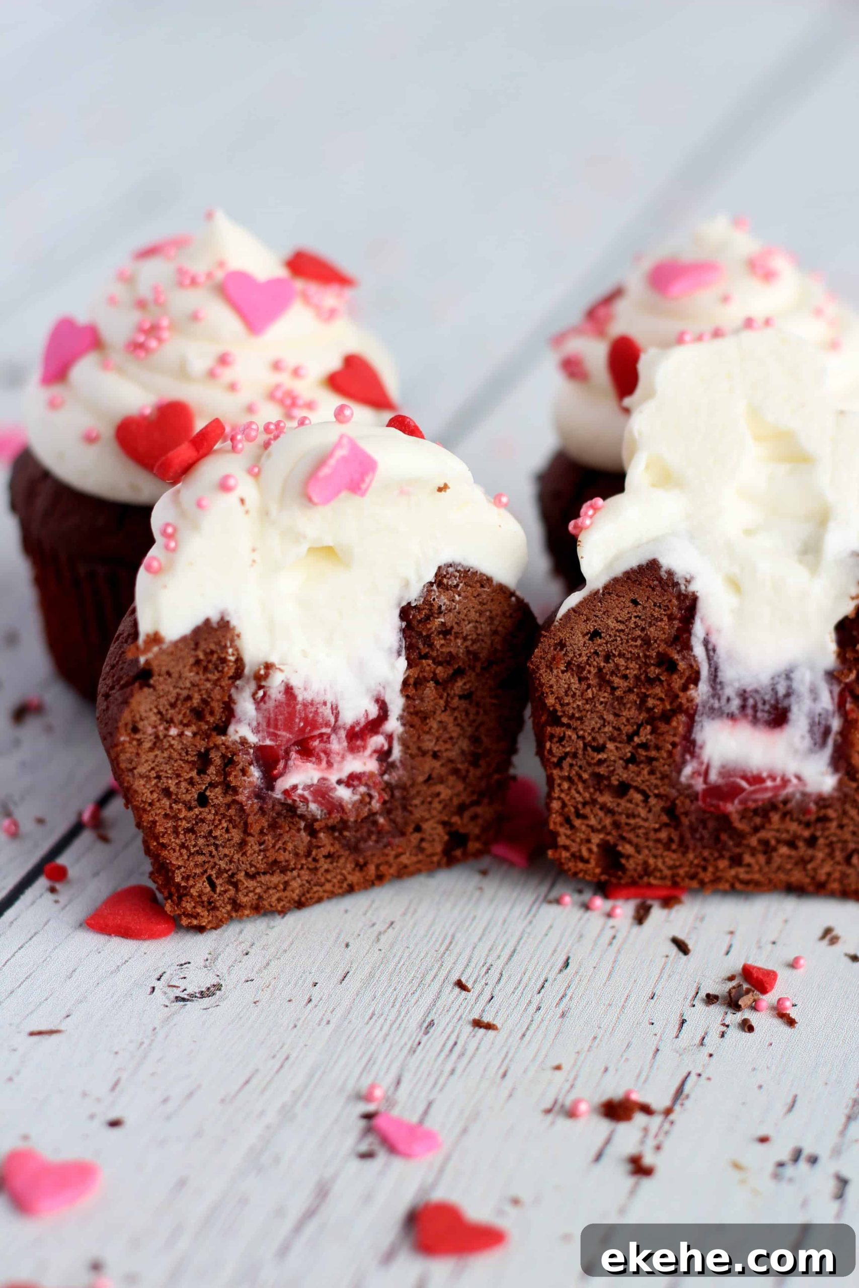 cupcakes with cherry filling and whipped cream