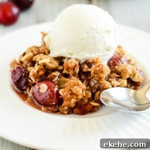 plate of cherry crisp with a spoon