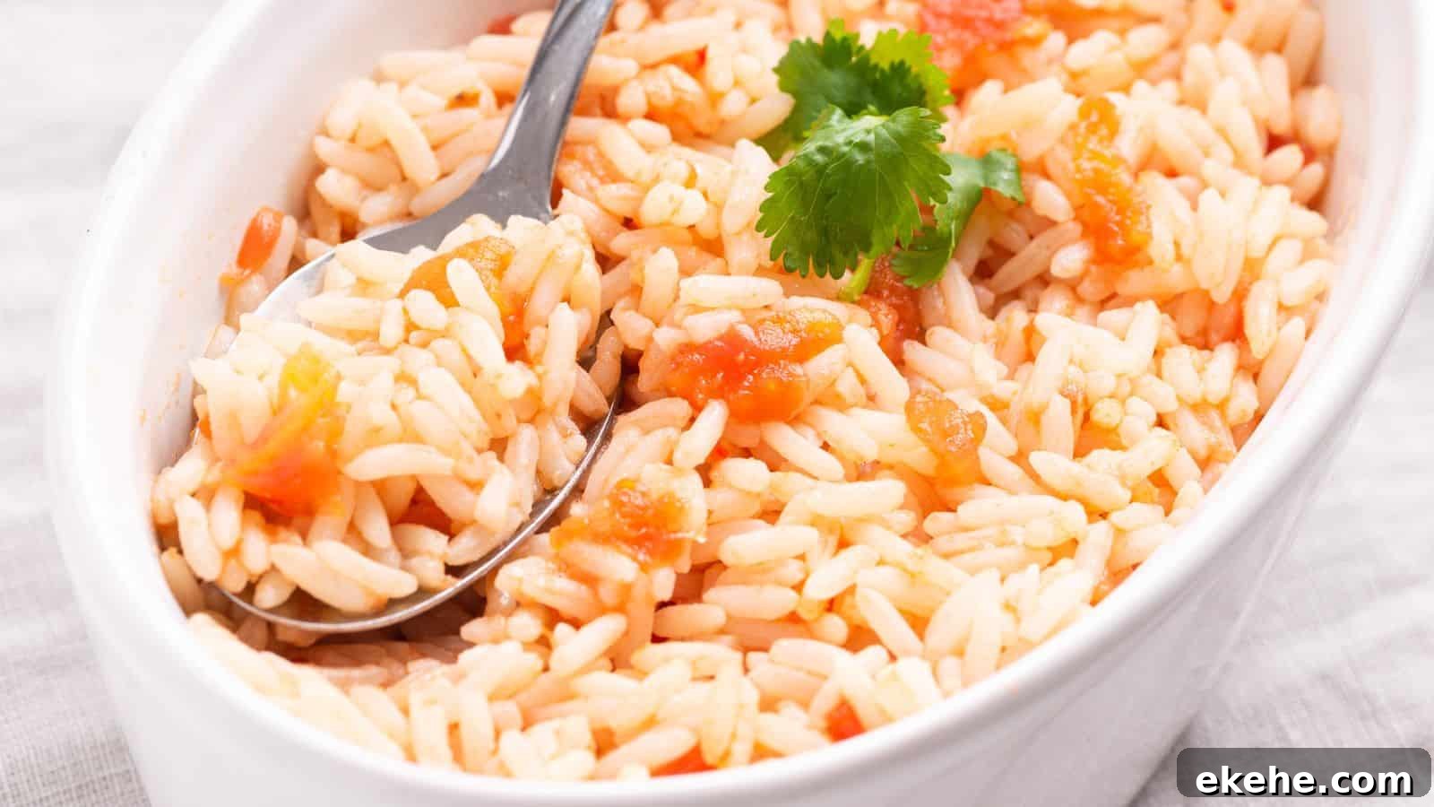 Mexican rice in small oval serving dish with spoon.