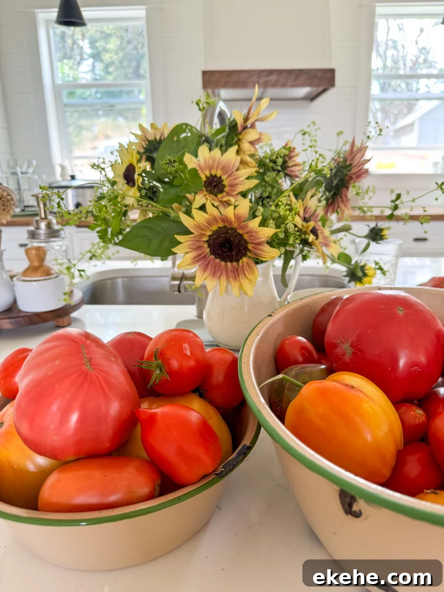 a vase of sunflowers and bowls of tomatoes