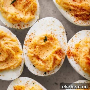 Classic Deviled Eggs with sprinkled spices on top on a plate