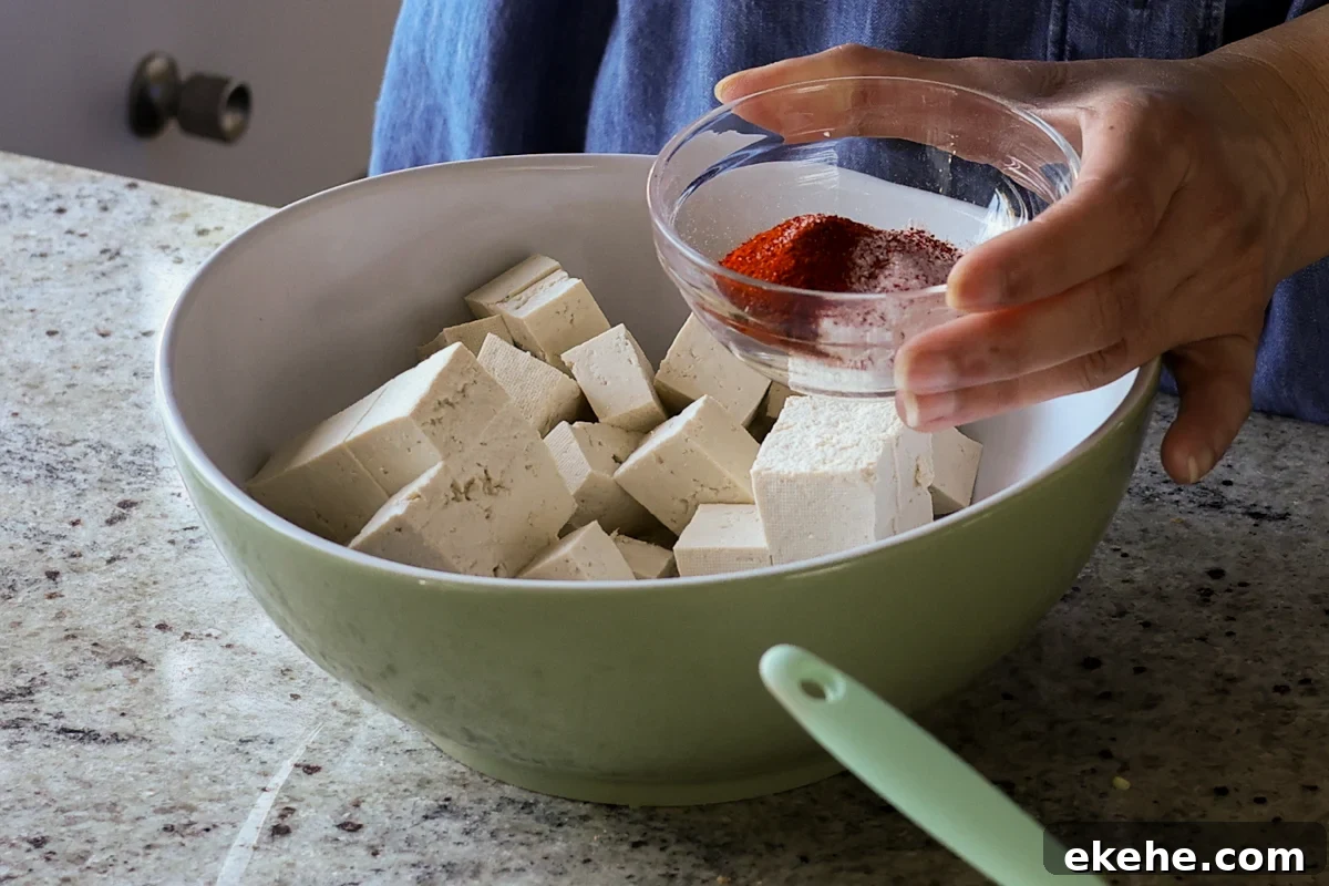 adding spices to the tofu