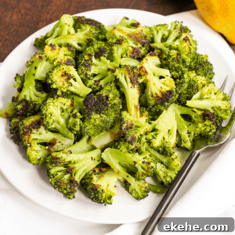 roasted broccoli on a plate with lemons