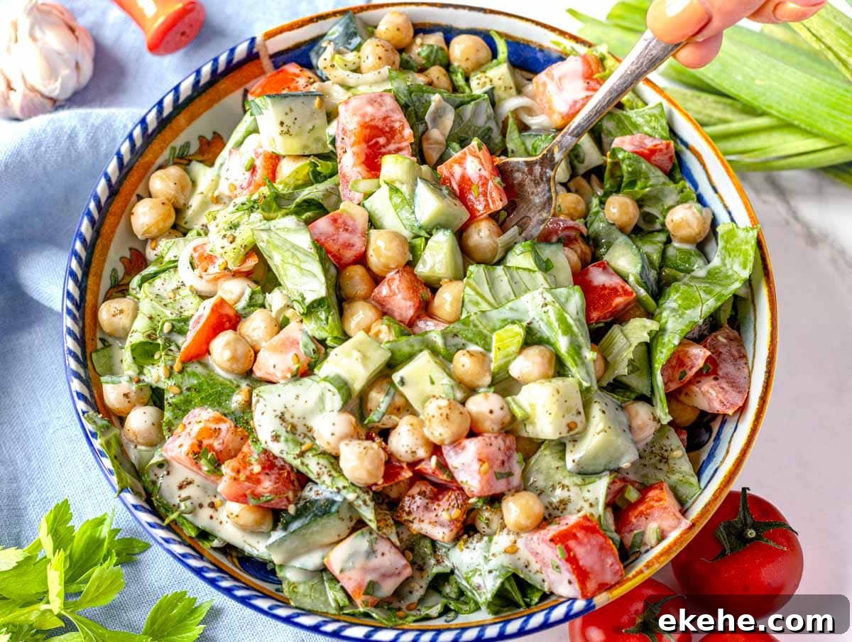 Tahini salad with hand holding a fork