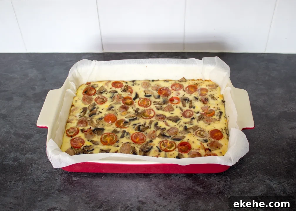 A full English baked frittata in a lined ovenproof dish