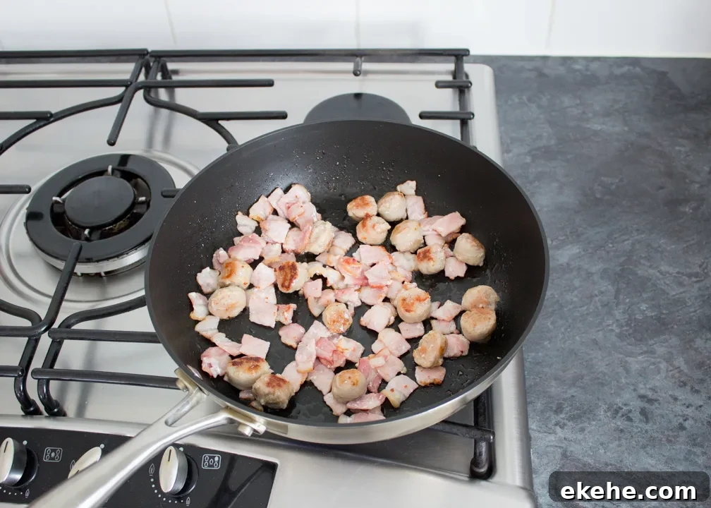 Sausage and bacon cooking in a frying in a pan