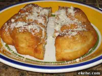 Serve the bread topped with grated myzithra cheese.