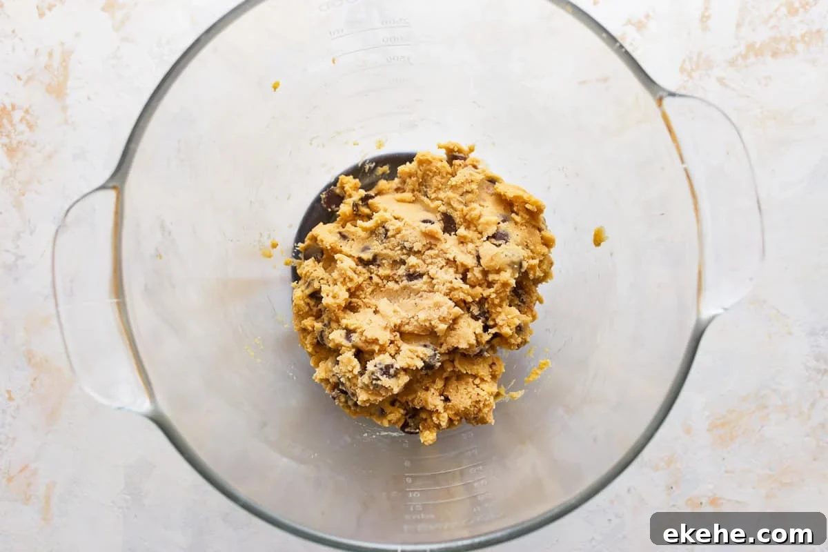 chocolate chip walnut cookie dough in a glass bowl.
