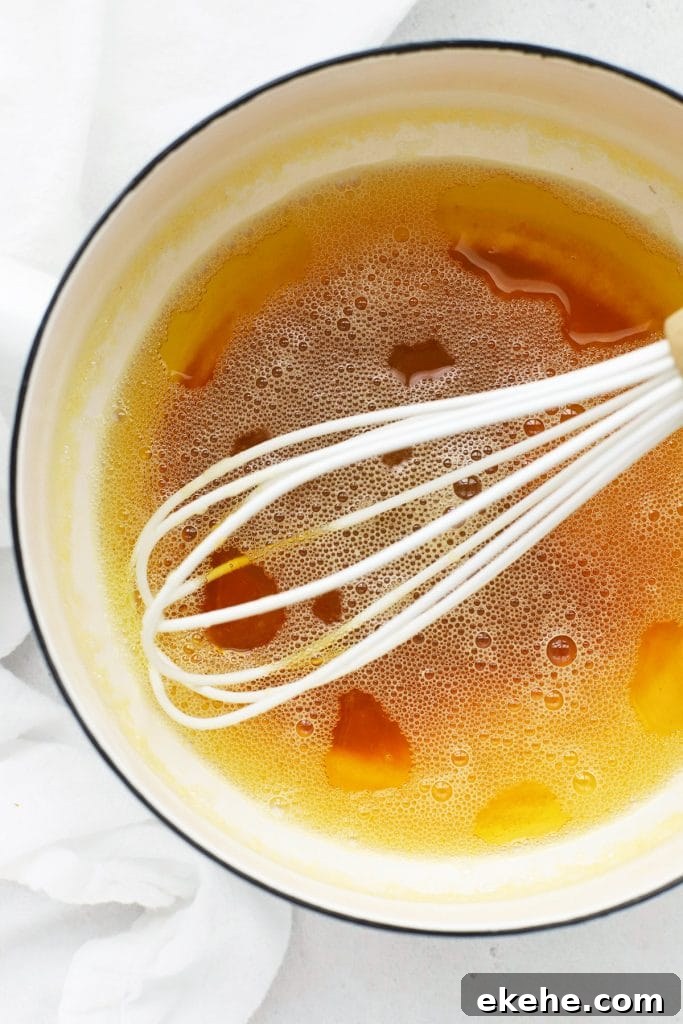 Close up overhead view of browned butter in a white saucepan