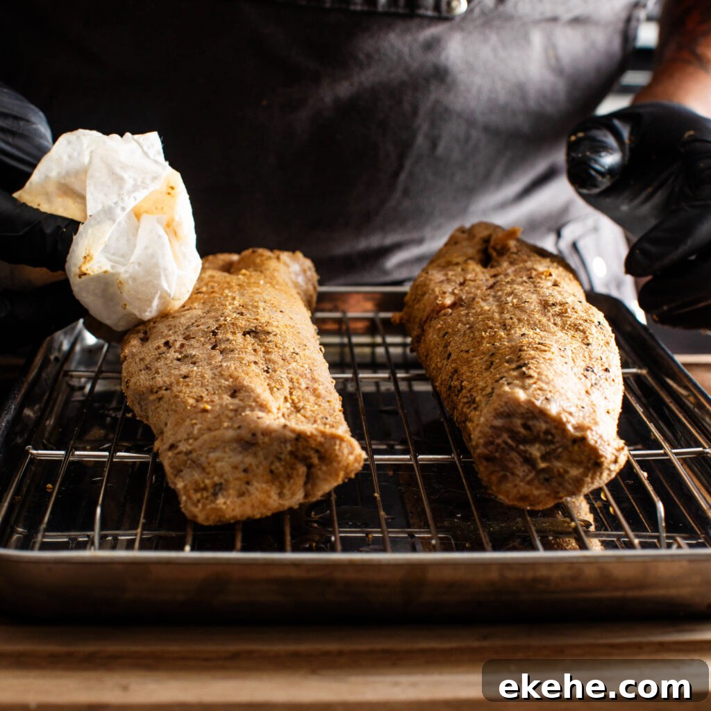 patting sous vide pork tenderloin dry with paper towels