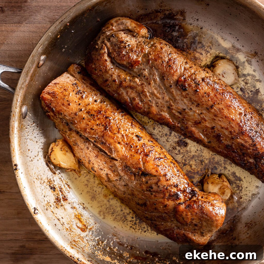 searing pork tenderloins and garlic in a pan