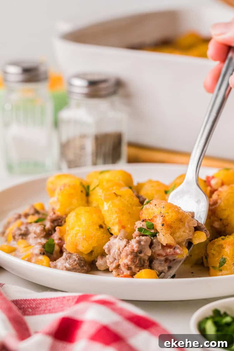 using a fork to eat the Cowboy Casserole.