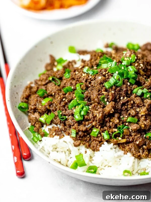 Korean beef bowl with rice and red chopsticks; bulgogi bowl