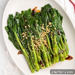 Plate of stir fried Chinese Broccoli with oyster sauce and fried garlic.