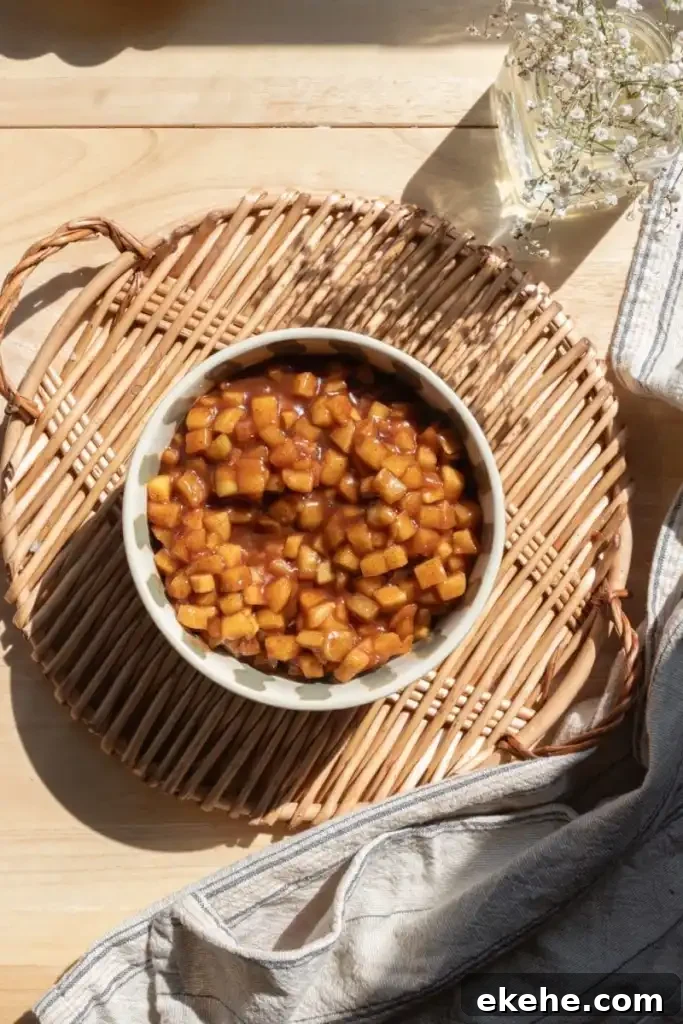 The apple pie filling in a bowl on a serving tray.